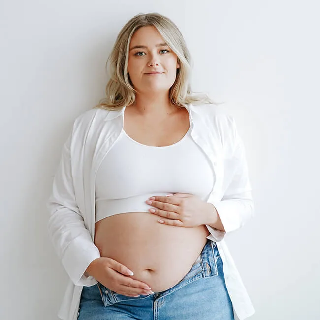 photo of a pregnant woman in a white top and jeans during a professional maternity photoshoot in Glasgow